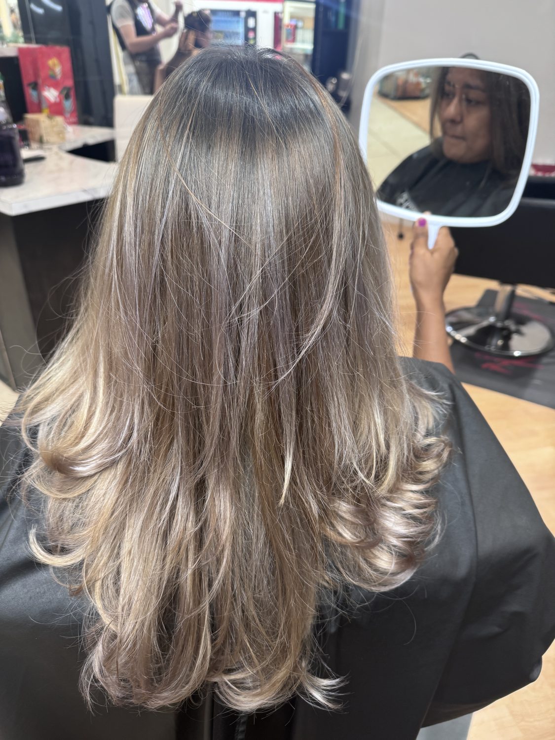 Golden blonde balayage with a soft grown-out root