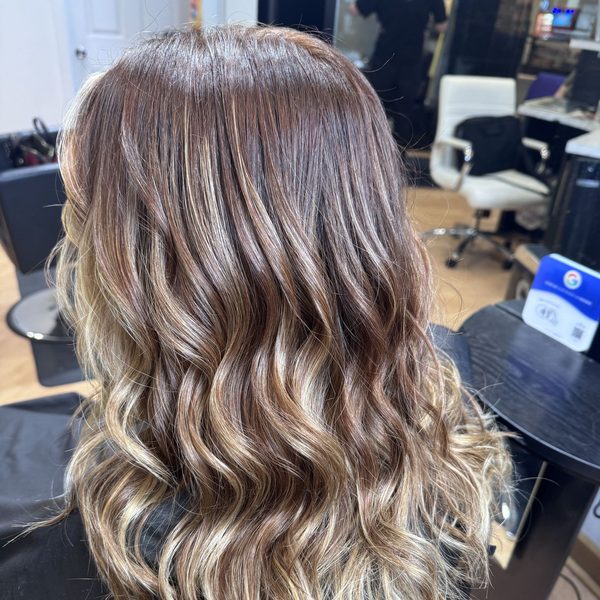 Warm brunette balayage in soft waves