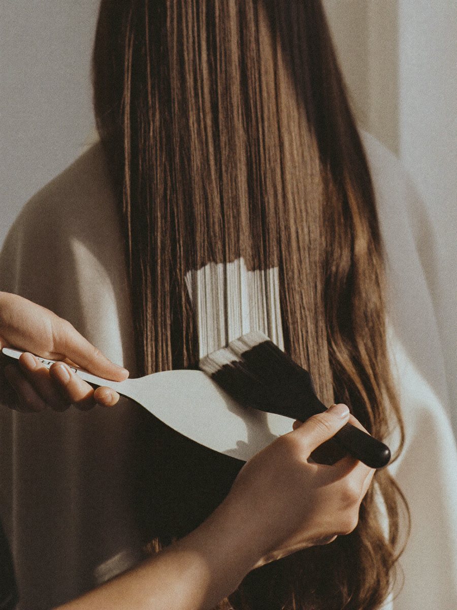 Freehand balayage being painted onto long brown hair
